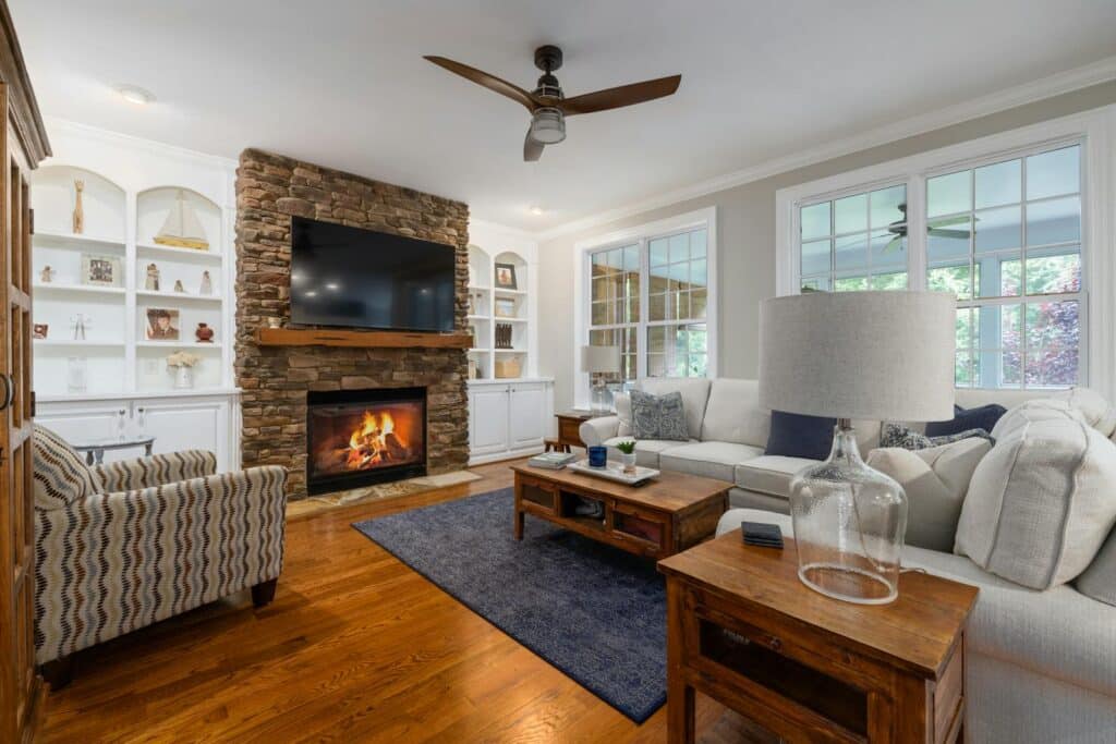 Explore a chic living room featuring a stone fireplace, modern furnishings, and elegant decor.